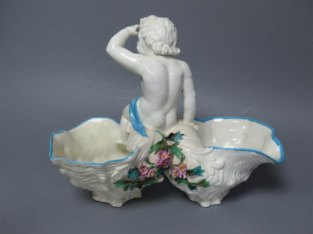 A large late 19th century French porcelain figure of Cupid, an English bone china cherub vase and a similar sweetmeat dish, tallest 3